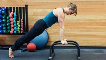 Practicing Bodyweight Plank Hold on Parallettes